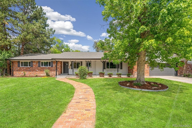 423 Nile St, Aurora, CO 80010 - single story home featuring driveway, a front lawn, brick siding, an attached garage, and a porch