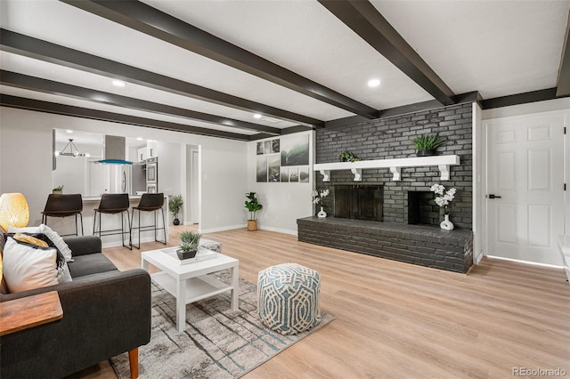 423 Nile St, Aurora, CO 80010 - living room with wood finished floors, beam ceiling, baseboards, and a fireplace