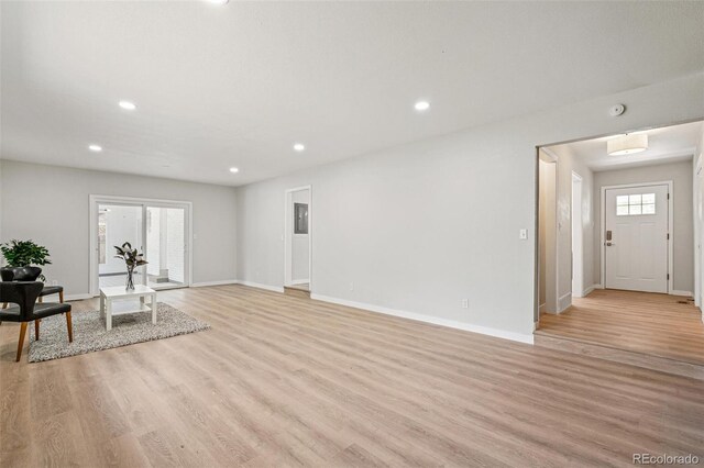 423 Nile St, Aurora, CO 80010 - unfurnished living room with light wood-type flooring, baseboards, and recessed lighting