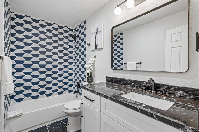 423 Nile St, Aurora, CO 80010 - full bathroom featuring vanity, toilet,  shower combination, and marble finish flooring