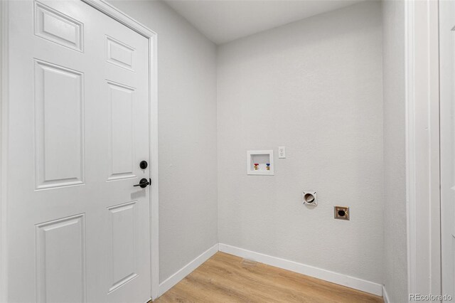 423 Nile St, Aurora, CO 80010 - washroom with hookup for an electric dryer, washer hookup, light wood-style flooring, and baseboards