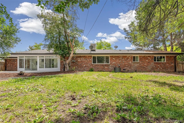 423 Nile St, Aurora, CO 80010 - rear view of property with a sunroom, brick siding, and central AC unit