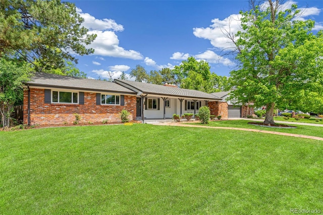 423 Nile St, Aurora, CO 80010 - single story home featuring an attached garage, a front lawn, and brick siding