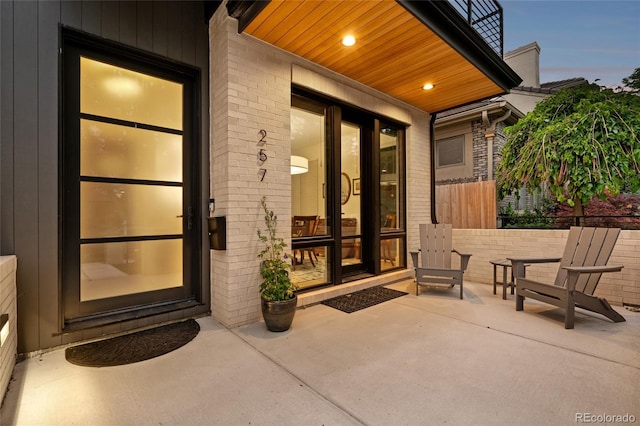 exterior entry at dusk featuring a patio