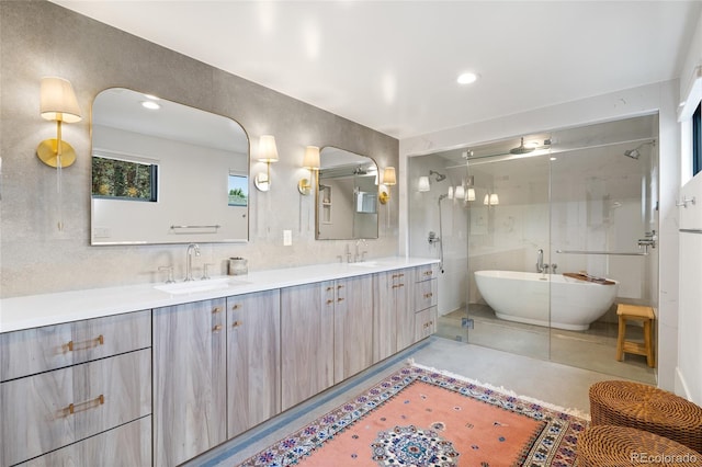 bathroom with vanity, shower with separate bathtub, and concrete floors