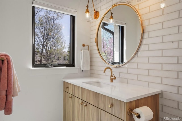 bathroom with vanity and decorative backsplash