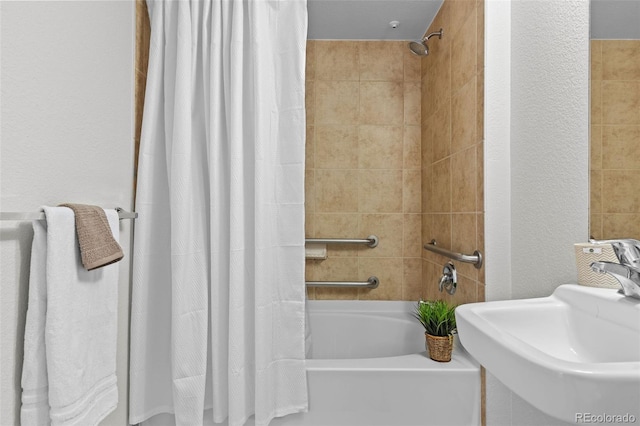 bathroom with sink and shower / bath combination with curtain