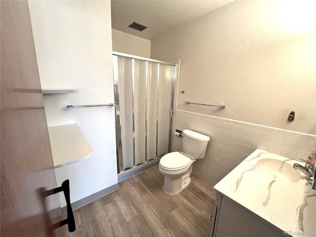 775 S Alton Way Unit 3D, Denver, CO 80247 - full bath featuring wood finished floors, vanity, toilet, tile walls, and a shower stall