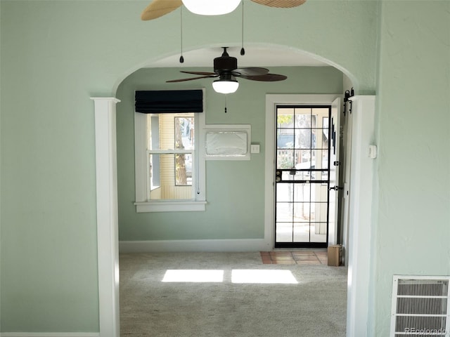 empty room featuring light carpet and ceiling fan