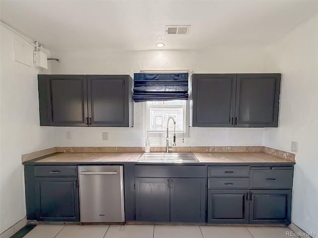 kitchen with light tile patterned flooring, sink, and dishwasher