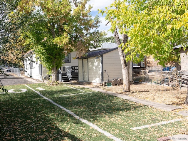 exterior space with a front lawn and a wooden deck