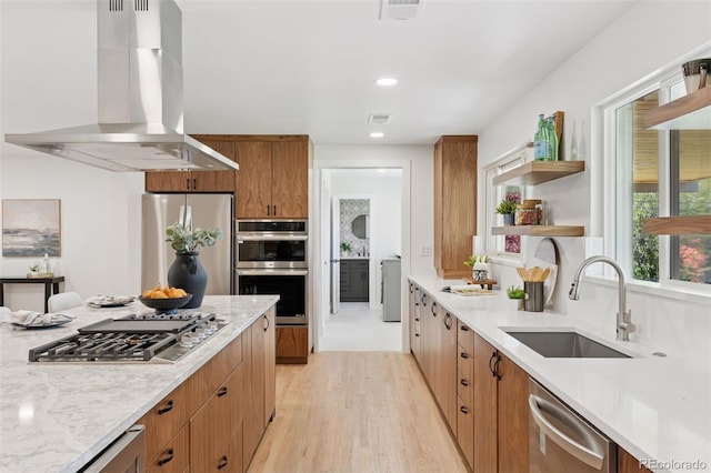 3775 S Forest Way, Denver, CO 80237 - kitchen featuring island exhaust hood, stainless steel appliances, a sink, open shelves, and light wood-type flooring