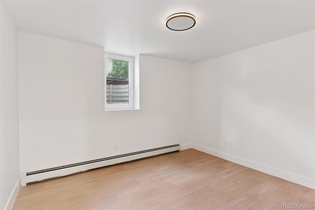 3775 S Forest Way, Denver, CO 80237 - spare room with a baseboard heating unit, light wood finished floors, and baseboards