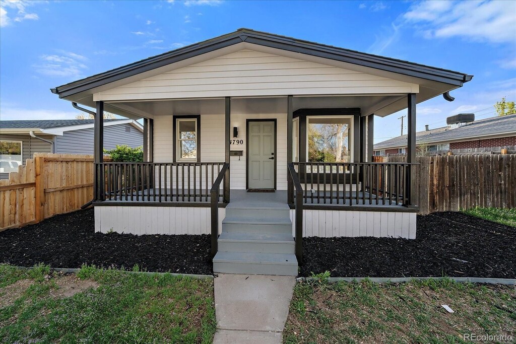 4790 S Cherokee St, Englewood, CO 80110 - view of front of property featuring covered porch and fence