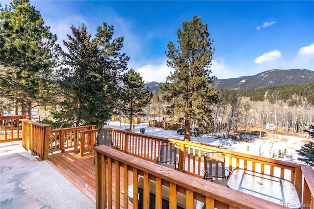 snow covered deck featuring a mountain view