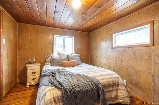 bedroom with hardwood / wood-style floors, wooden ceiling, and wooden walls