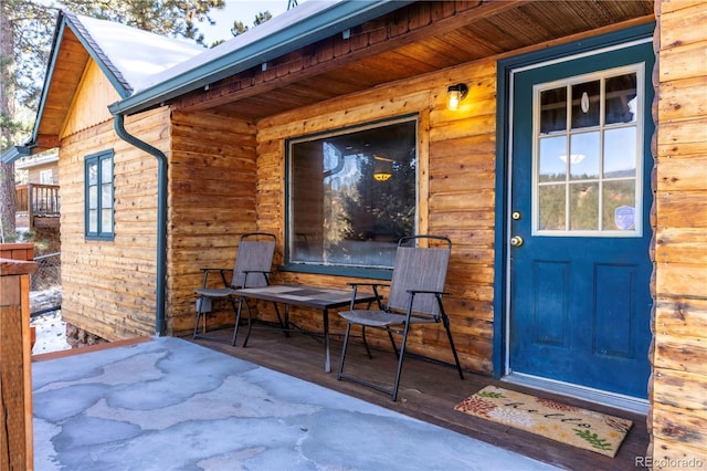 view of exterior entry with covered porch