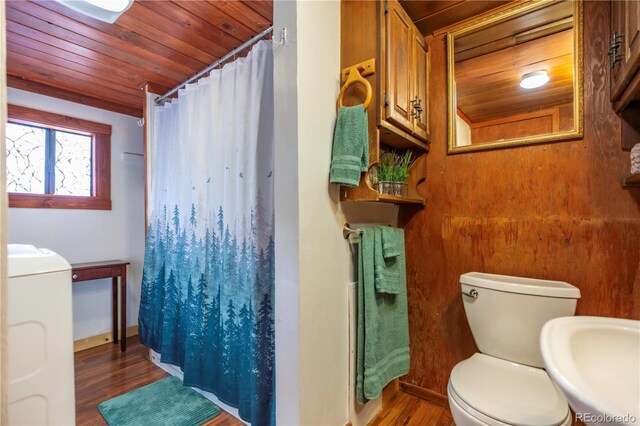 296 Anderson Rd, Bailey, CO 80421 - bathroom featuring washer / clothes dryer, wood finished floors, toilet, wooden ceiling, and curtained shower