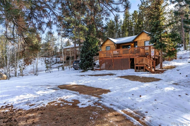 296 Anderson Rd, Bailey, CO 80421 - snow covered back of property with stairway and a wooden deck