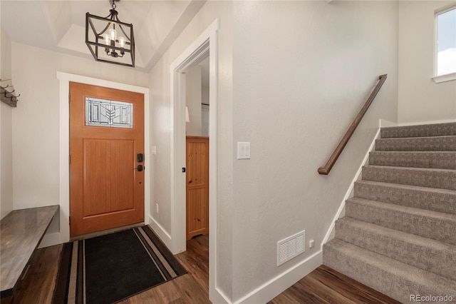 719 Saddle Ridge Cir, Granby, CO 80446 - foyer featuring dark wood finished floors, stairs, a chandelier, and baseboards