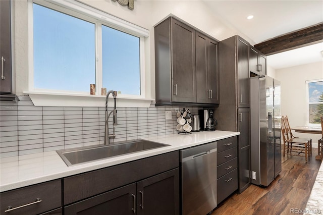 719 Saddle Ridge Cir, Granby, CO 80446 - kitchen featuring appliances with stainless steel finishes, a sink, beam ceiling, dark brown cabinets, and dark wood finished floors
