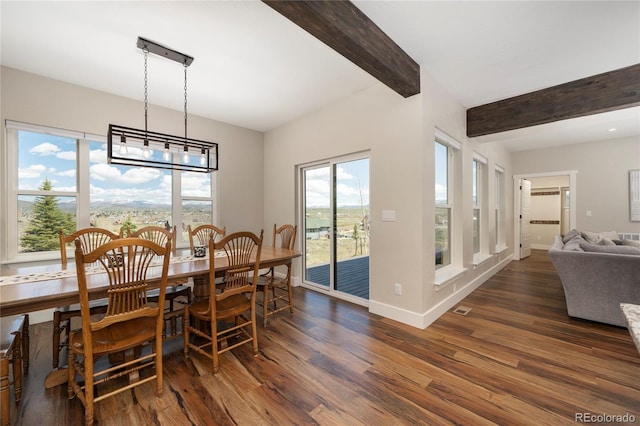 719 Saddle Ridge Cir, Granby, CO 80446 - dining space with beam ceiling, dark wood-style flooring, and baseboards