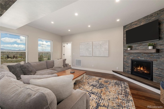 719 Saddle Ridge Cir, Granby, CO 80446 - living room featuring baseboards, wood finished floors, a stone fireplace, and recessed lighting