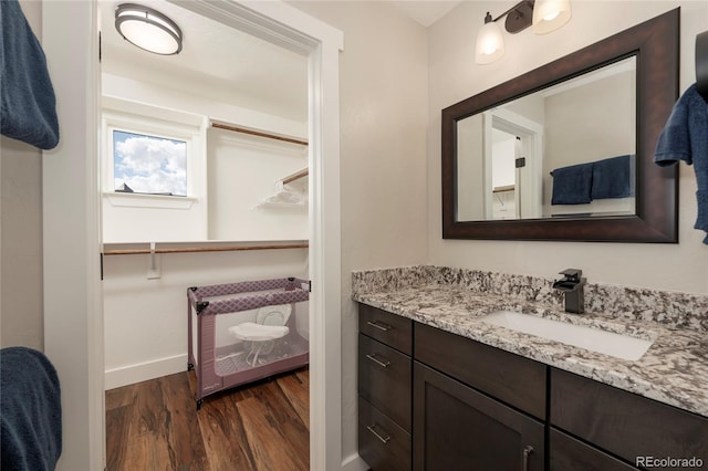 719 Saddle Ridge Cir, Granby, CO 80446 - bathroom with wood finished floors, vanity, and baseboards
