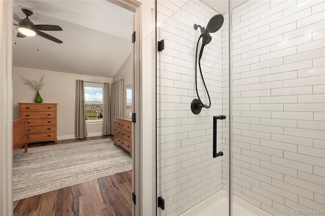 719 Saddle Ridge Cir, Granby, CO 80446 - full bathroom with vaulted ceiling, a shower stall, wood finished floors, ceiling fan, and baseboards