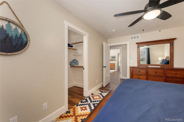 719 Saddle Ridge Cir, Granby, CO 80446 - bedroom with baseboards, wood finished floors, a walk in closet, and a ceiling fan