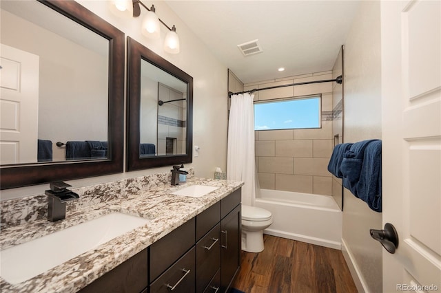 719 Saddle Ridge Cir, Granby, CO 80446 - bathroom featuring wood finished floors, shower / tub combo with curtain, toilet, double vanity, and baseboards