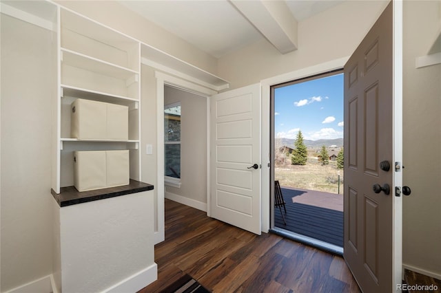719 Saddle Ridge Cir, Granby, CO 80446 - foyer featuring dark wood-style floors, a mountain view, baseboards, and beam ceiling