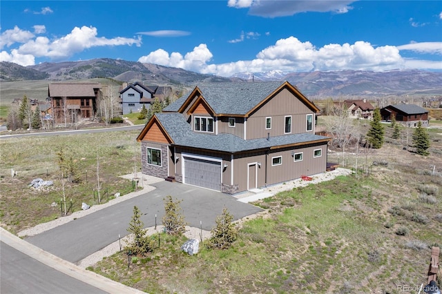719 Saddle Ridge Cir, Granby, CO 80446 - view of front of home featuring a mountain view, an attached garage, and asphalt driveway