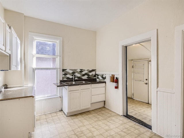 kitchen with plenty of natural light, sink, and white cabinets