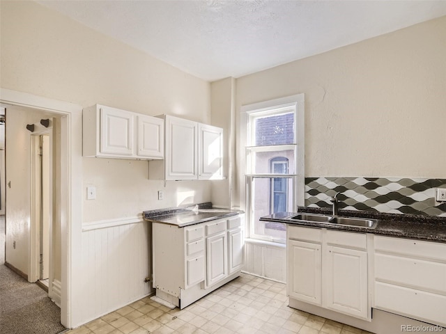 kitchen with white cabinetry and sink