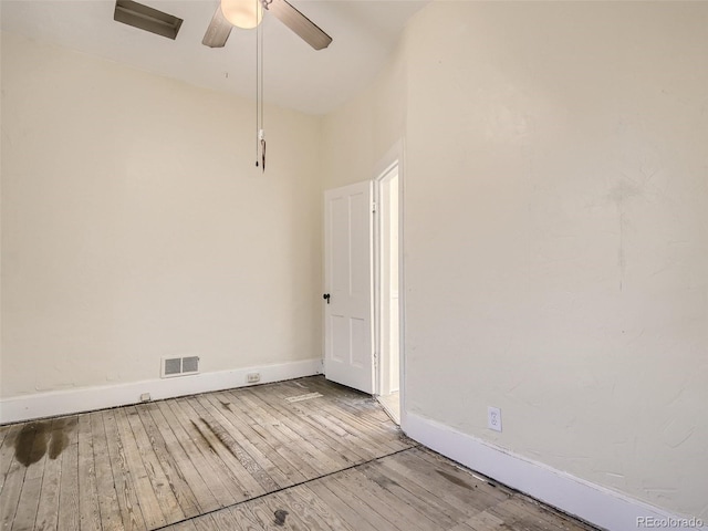 empty room featuring ceiling fan and light hardwood / wood-style floors