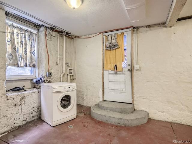 clothes washing area featuring washer / clothes dryer and a textured ceiling