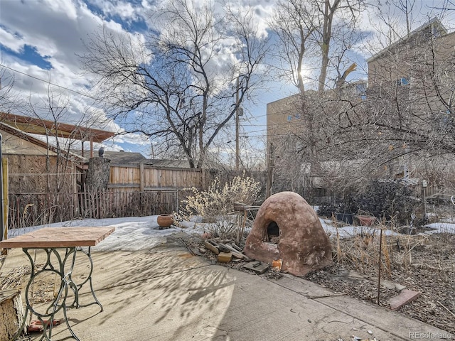 yard covered in snow with a patio area