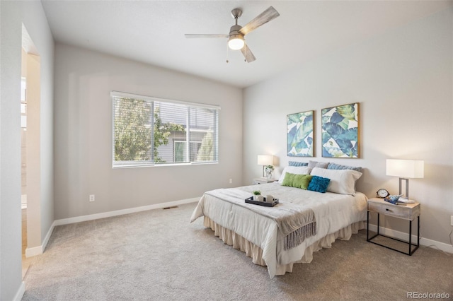 bedroom featuring light carpet, baseboards, and ceiling fan