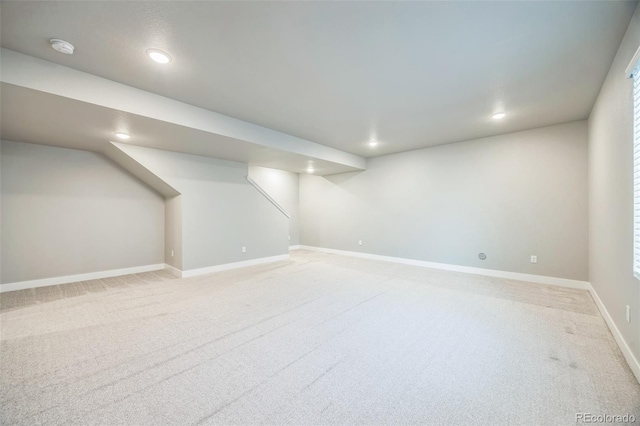 finished basement featuring light carpet, recessed lighting, and baseboards