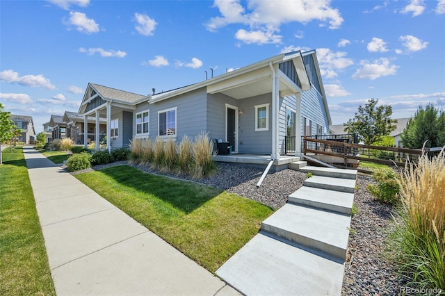 view of front facade with a front yard and covered porch