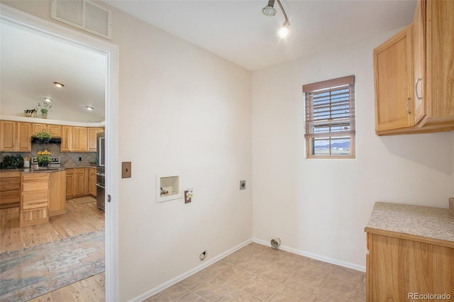 laundry area with cabinet space, hookup for a washing machine, baseboards, hookup for an electric dryer, and visible vents