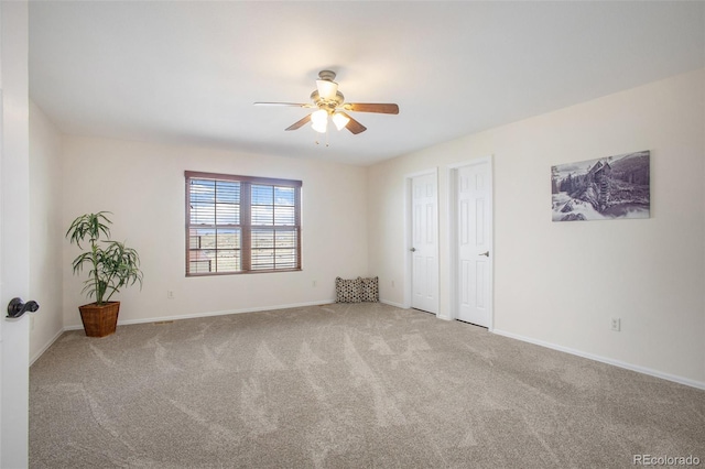 unfurnished room with baseboards, ceiling fan, and carpet