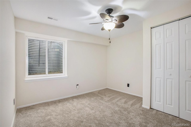 unfurnished bedroom with ceiling fan, carpet, baseboards, visible vents, and a closet