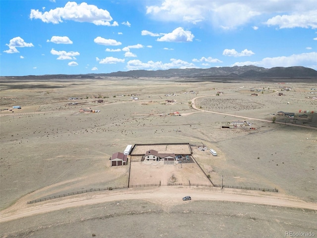 birds eye view of property with a mountain view, view of desert, and a rural view