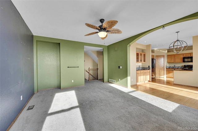 spare room with ceiling fan and light carpet