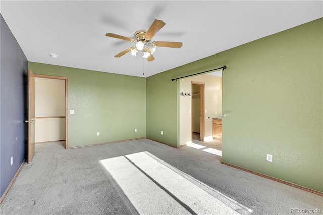 unfurnished bedroom featuring ceiling fan and light colored carpet