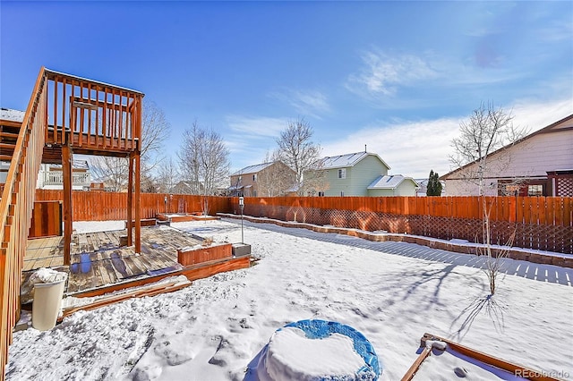 yard layered in snow with a wooden deck