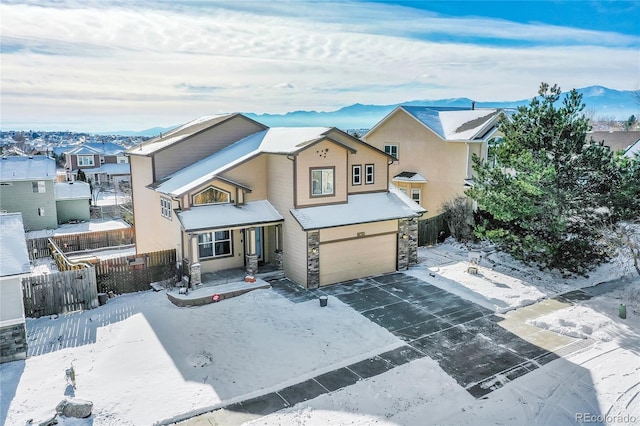 view of front of house featuring a garage and a mountain view