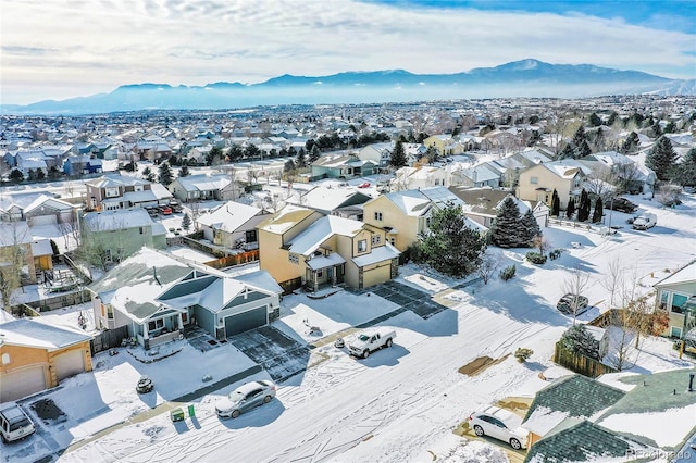 snowy aerial view featuring a mountain view